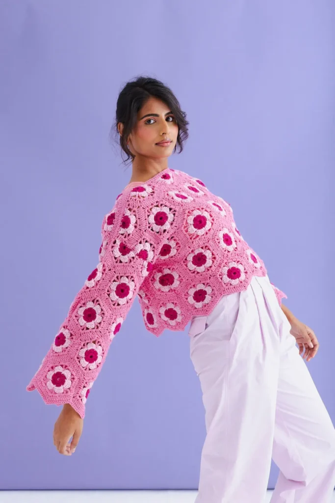 Pop of pink crocheted sweater by Cassie Ward