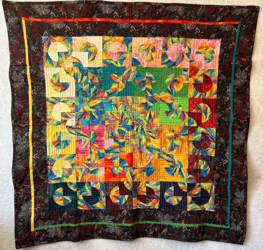 Drunkards path quilt in bright colors