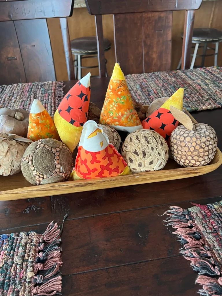 Candy corn bowlies with some gourds on the center of the table by Lane Johnson