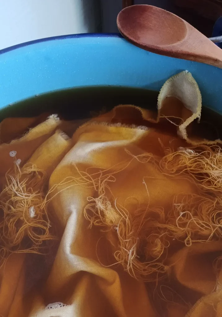 Vat of dye with fabric by Mildred & Sama of Suula