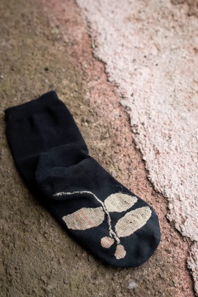 Mended sock in black and white by Minttu Wikberg