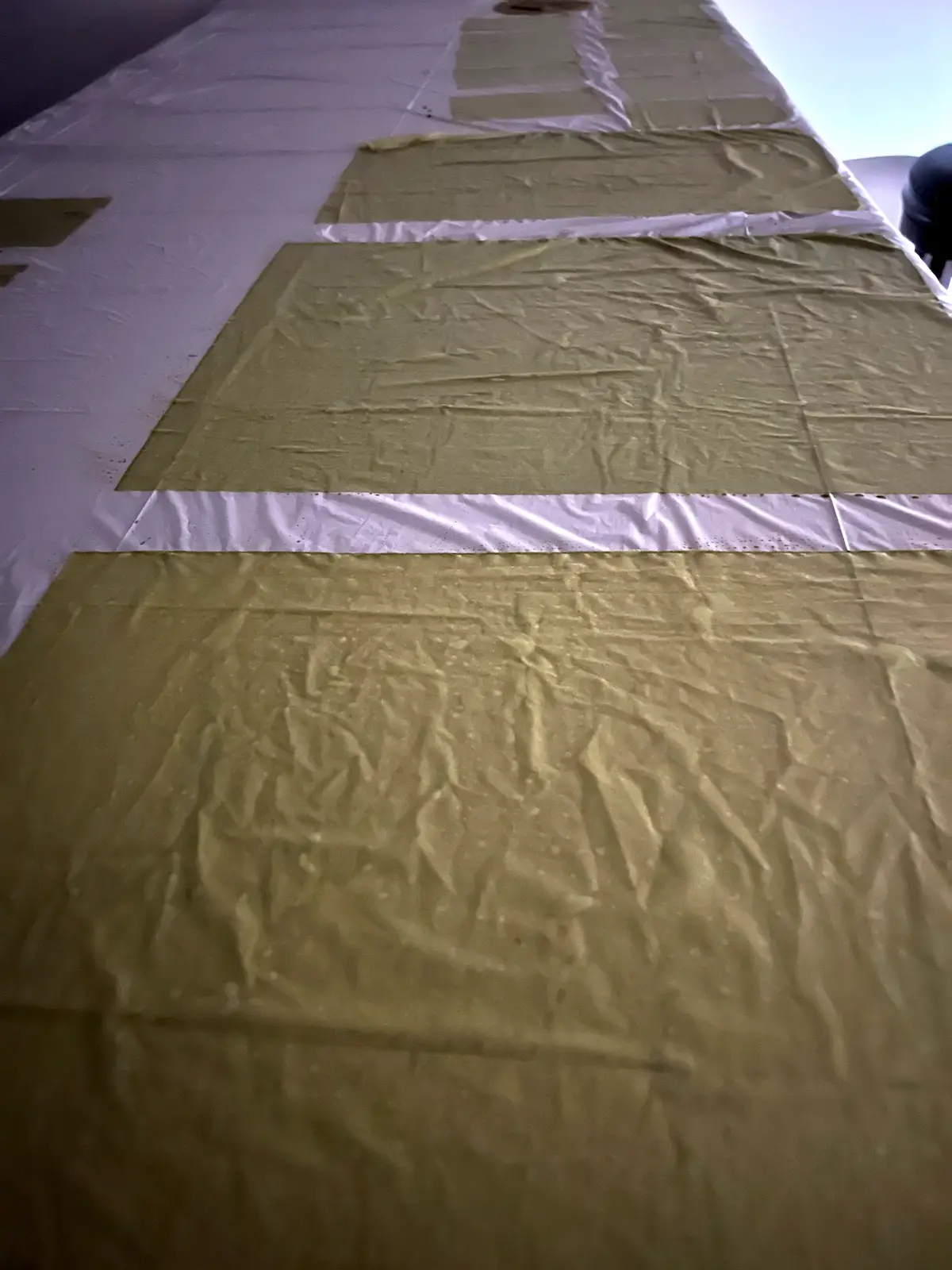 Cyanotype painted fabric drying in a dark room