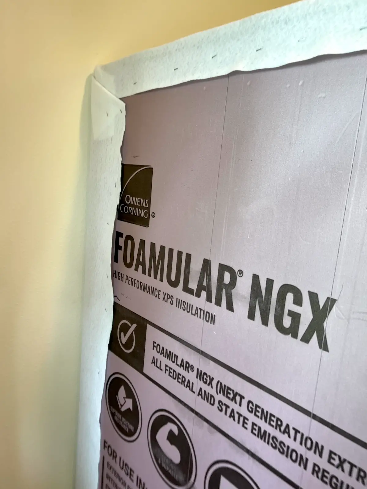 showing the felt wrapped to the back of the foam insulation and stapled