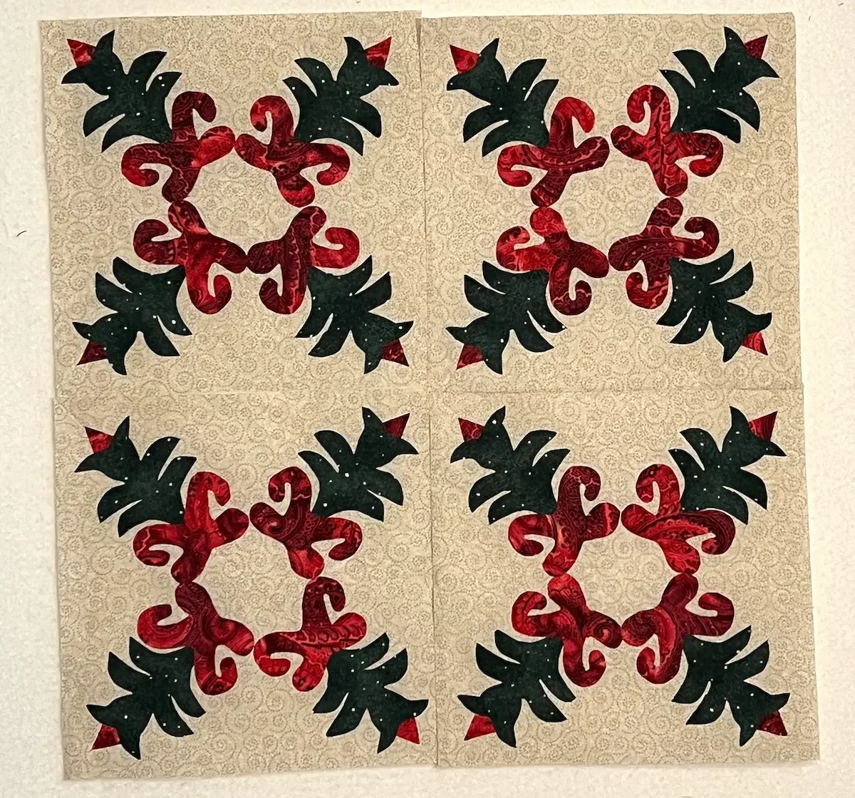 Here are four Christmas Cactus quilt blocks pressed and ready to be sewn together