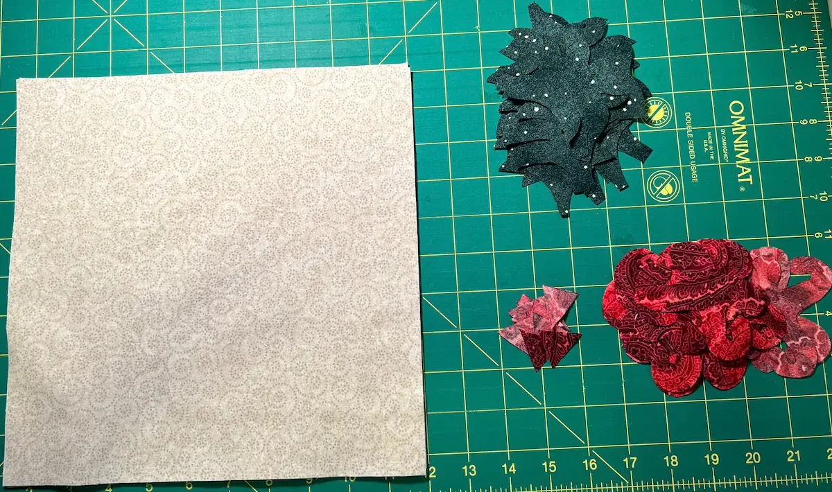 10-inch square of the background fabric and all of the elements for the Christmas Cactus all cut out