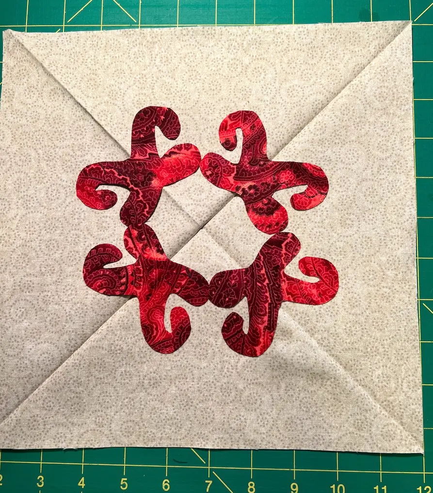 Start by placing the bottom of the Christmas Cactus centered around the center point on the square