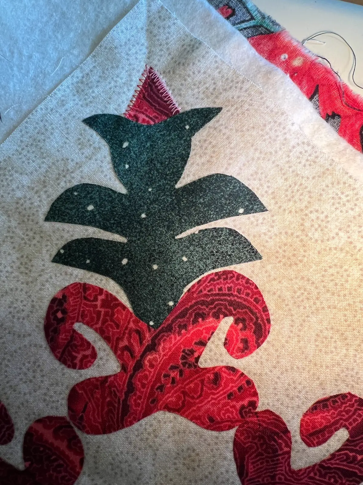 Start with the red bud and stitch around the raw edges. Don't stitch the part that is tucked into the green plant.