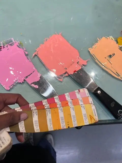 Jenn Graves checking paints with a pms color chart