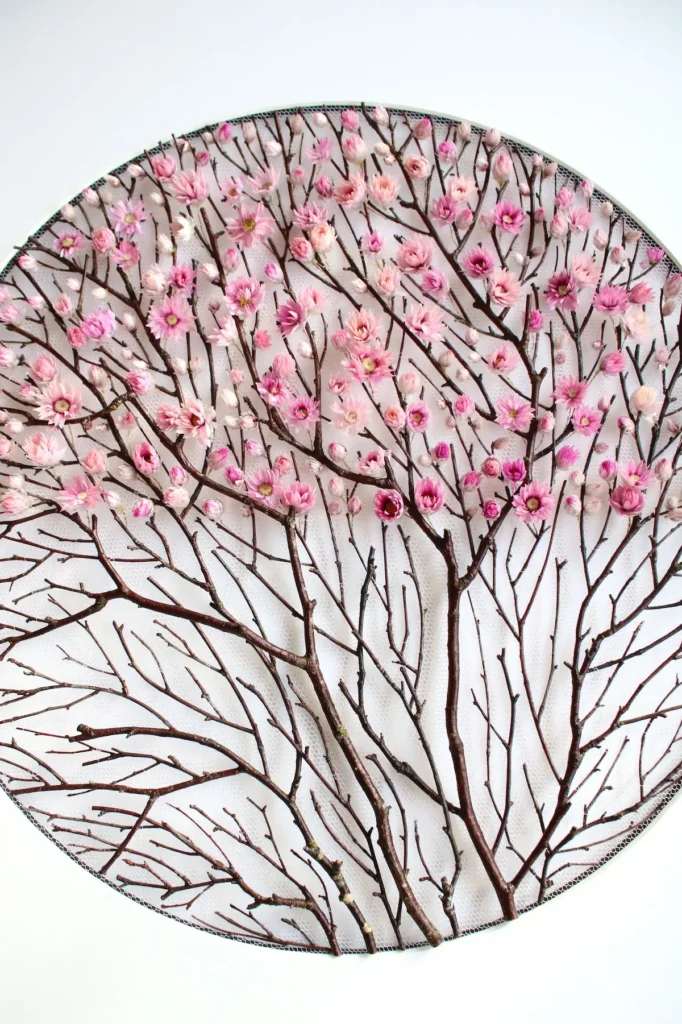 Showing the pink flowers on the tulle in the circle template by Olga Prinku