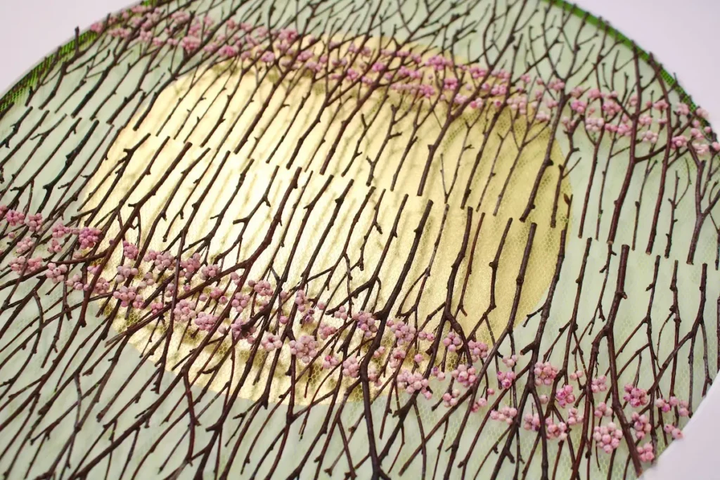 Showing the multiple layers of tulle, twigs and flowers in the circle template by Olga Prinku