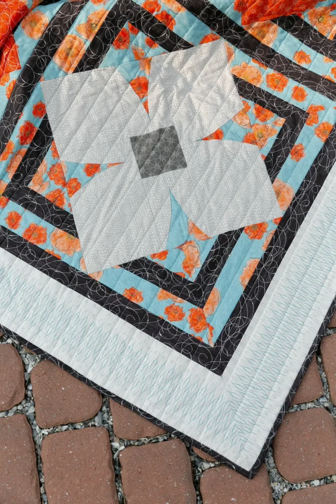 Twist quilt designed by Rachel Rossi and made with Modern Vintage Treasured Fabric Line