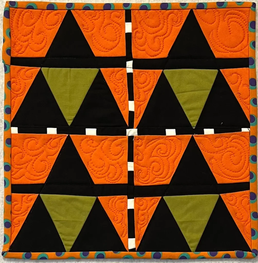 Four Witch quilt block sewn together to make a mini wall quilt