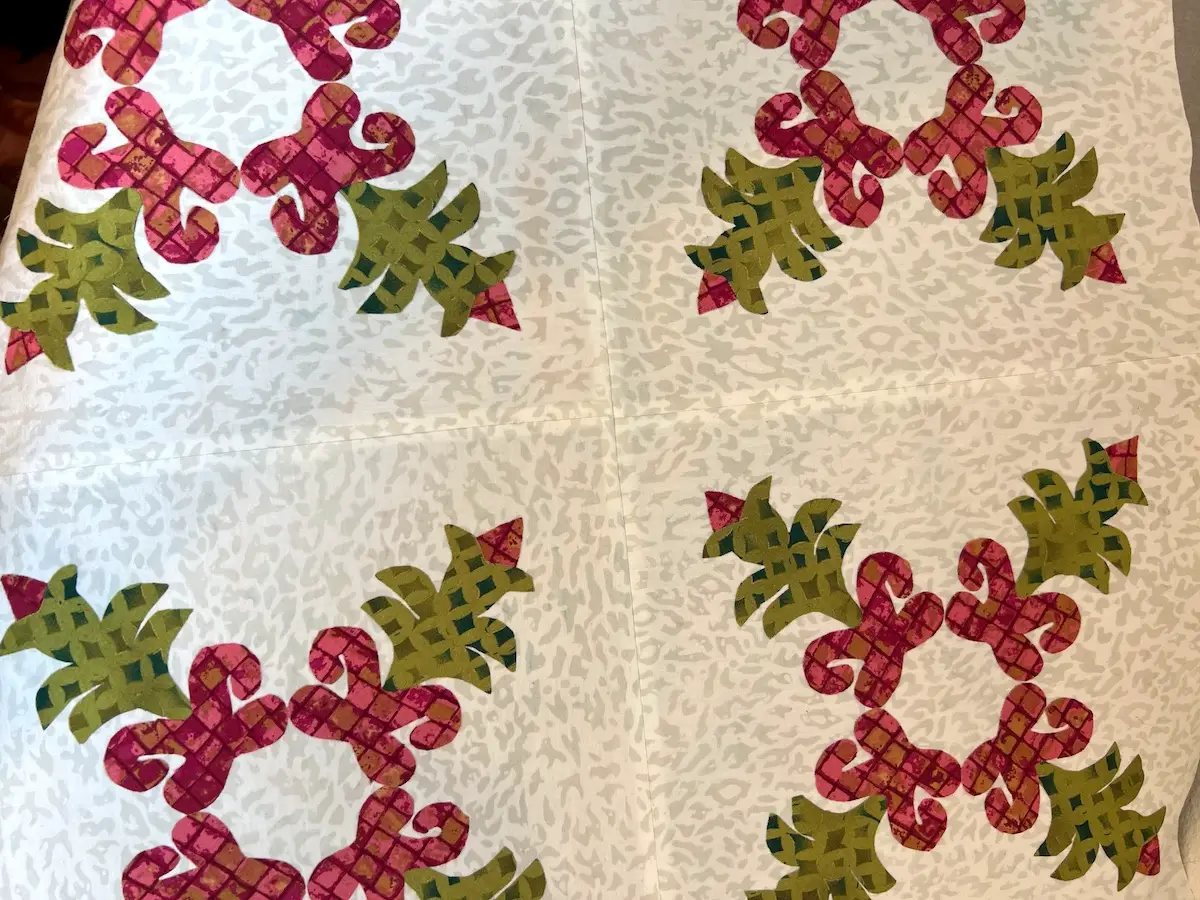 Christmas Cactus quilt block blocks sewn together and pressed. Ready for sandwiching and quilting