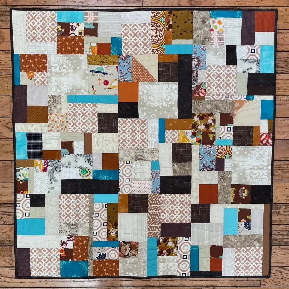 Blue and brown scrap quilt by Ethylene Ziegler