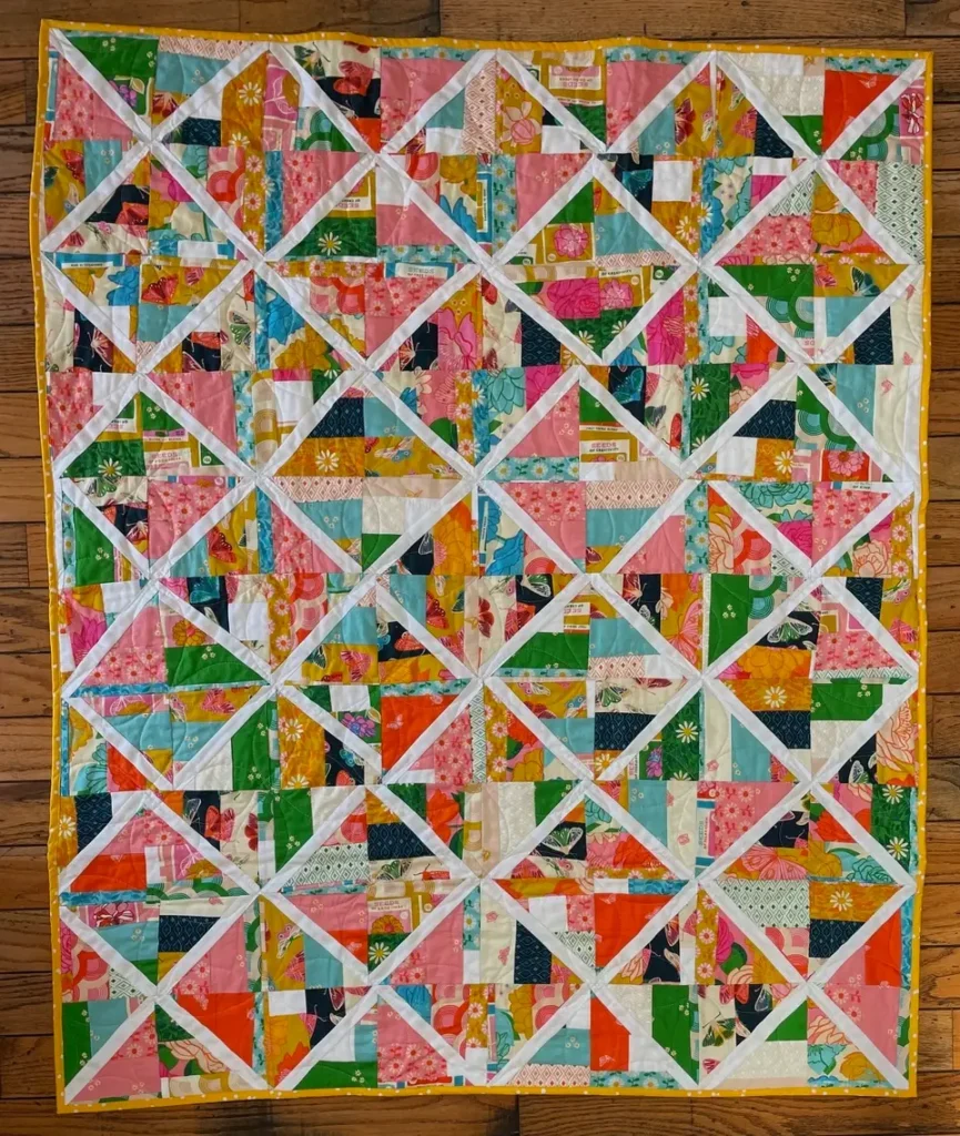 Quilt top made from a deconstucted jelly roll race top by Ethylene Ziegler