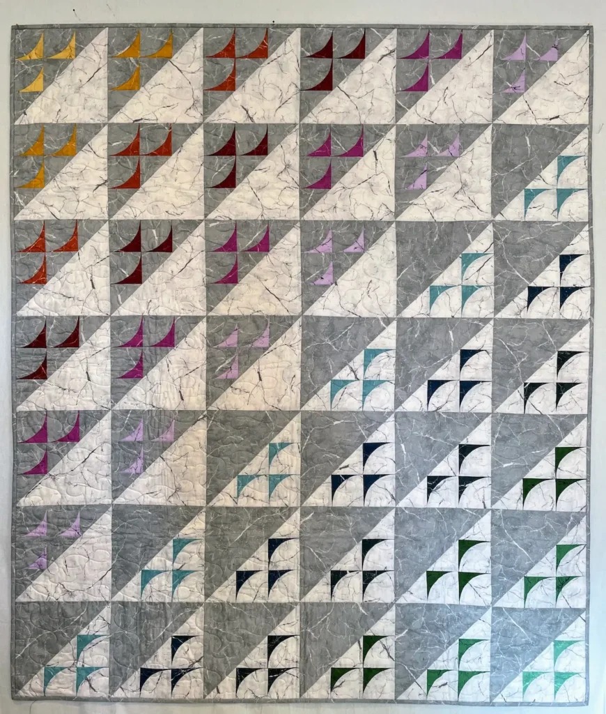 Drunkards path quilt in grey, white and colors by Jennifer Strauser