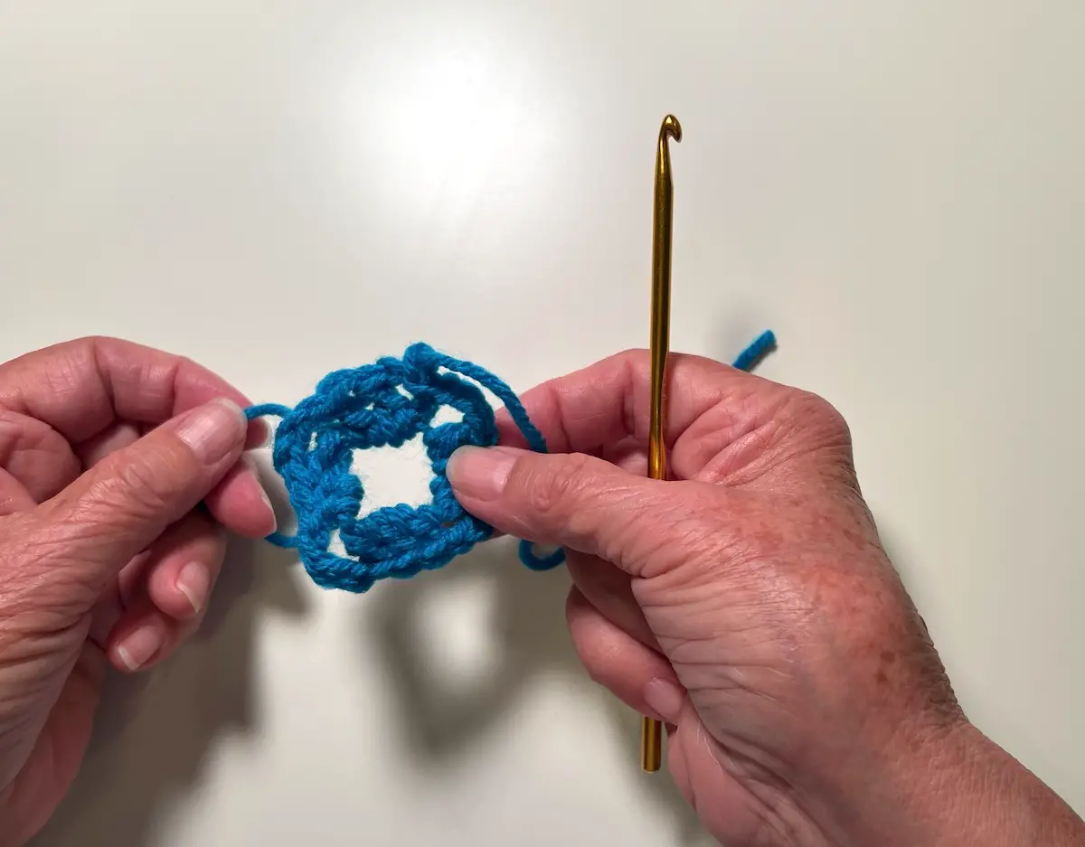 Here is the finished first round which is the center of the granny square. You can pull the tail to close the center