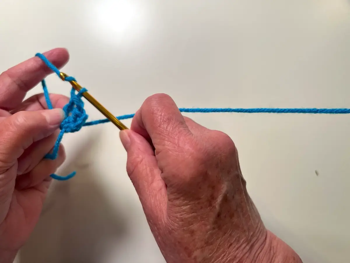 Finishing the first set of three stitches for the first row of the granny square