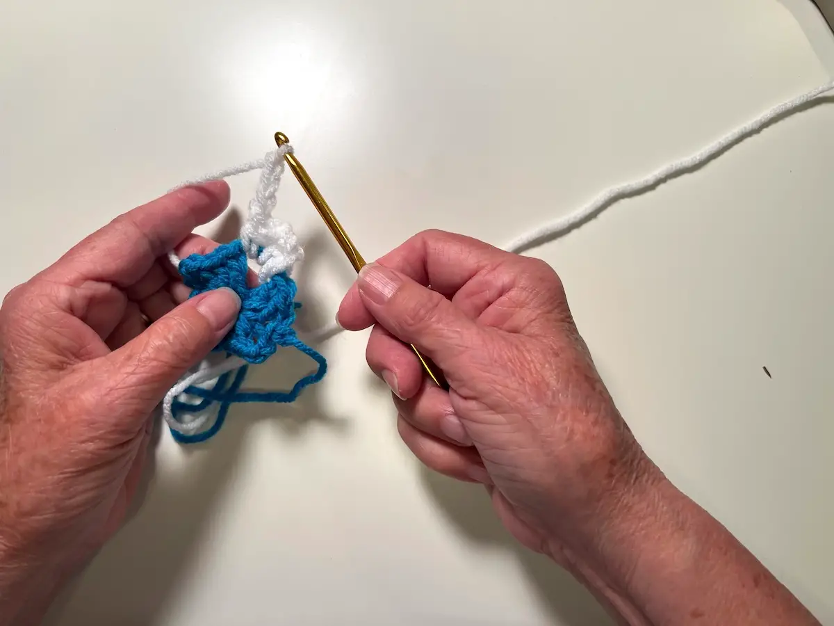 Chain stitch 3 stitches to form the corner for the second round of the granny square