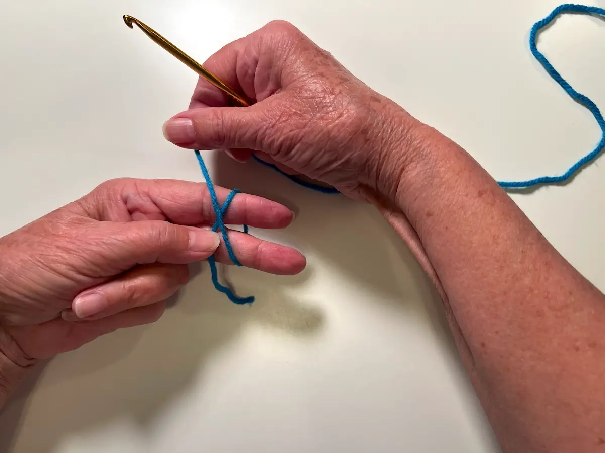 Next wrap the working yarn around to the back of your fingers forming an X for the magic circle for the granny square