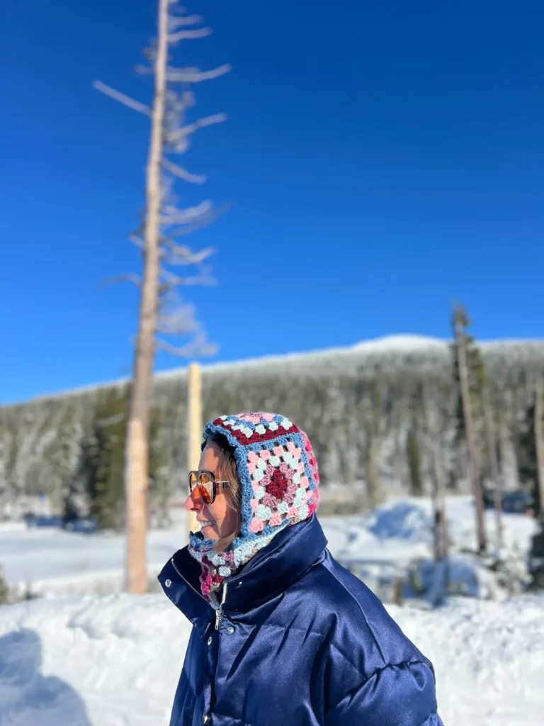 Bry with a partial front view of granny square balaclava on the mountain