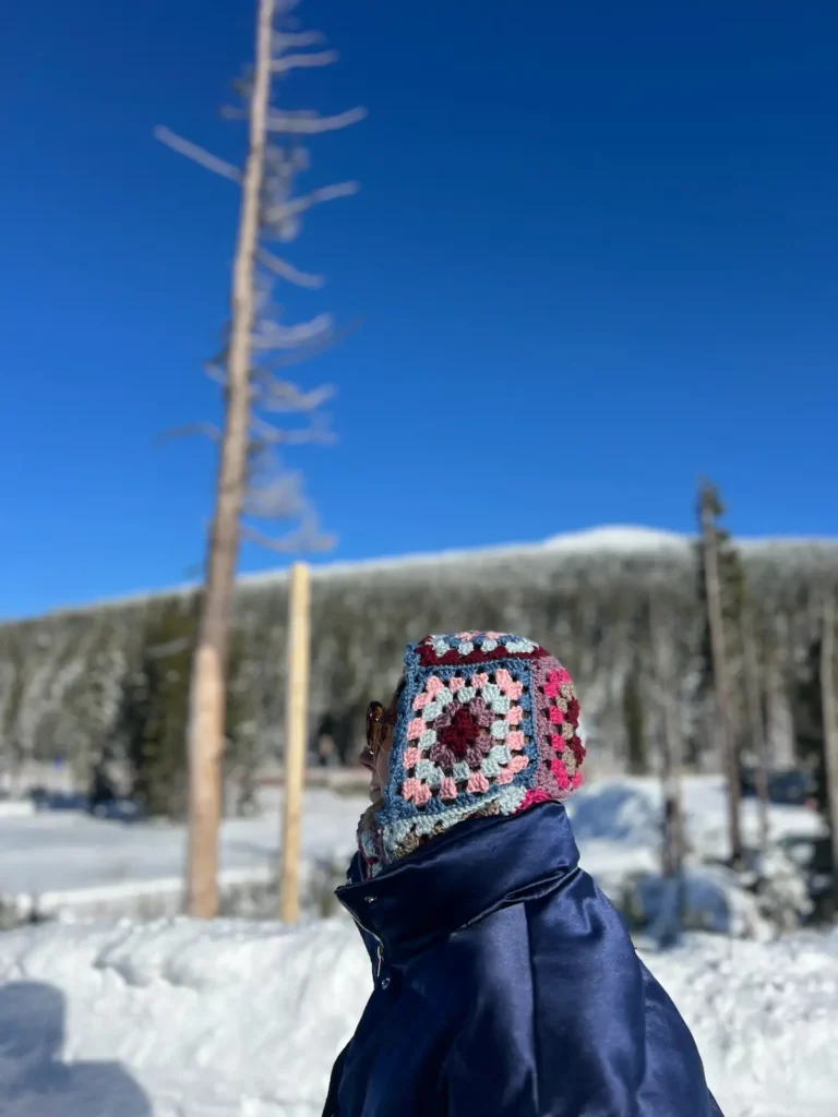 Bry with a side view of granny square balaclava on the mountain