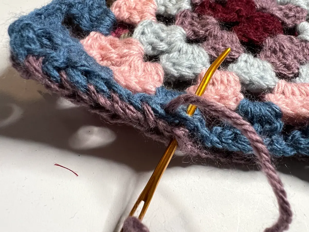 Whip stitching the granny squares together for the balaclava