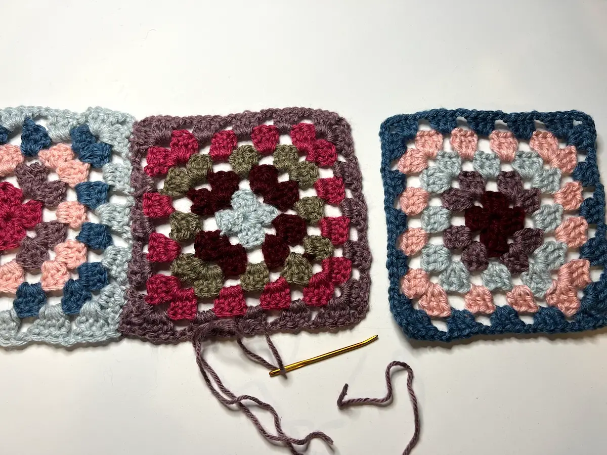 Two granny squares joined for the balaclava and ready to join the third