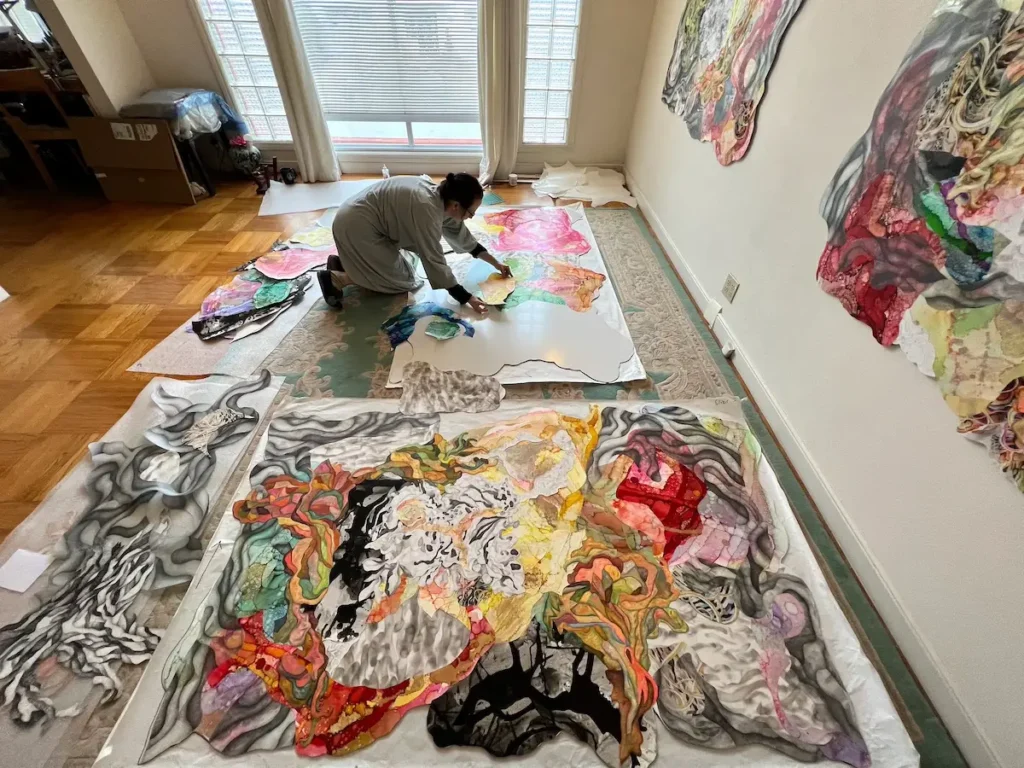 Holly Wong working on the floor on a piece