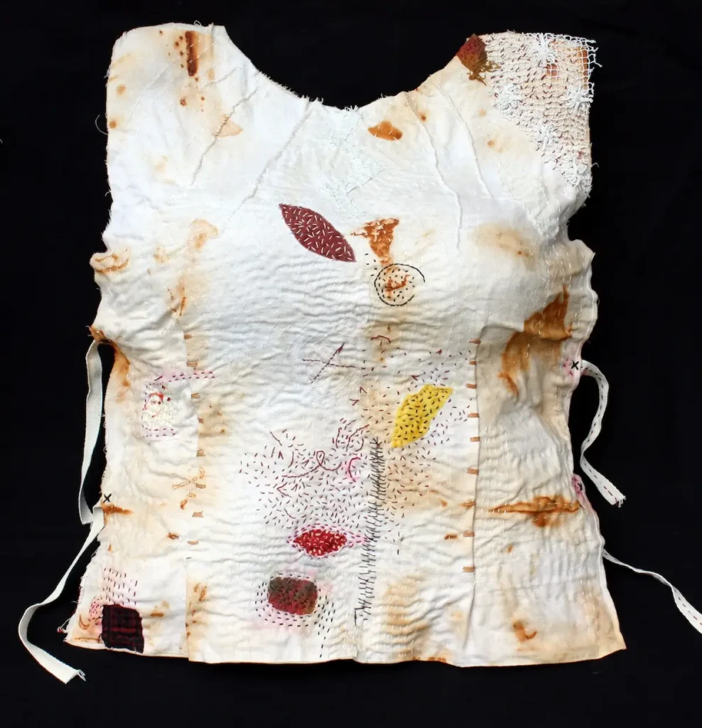 Women's PPE: Breastplate fiber art by Helen Geglio
