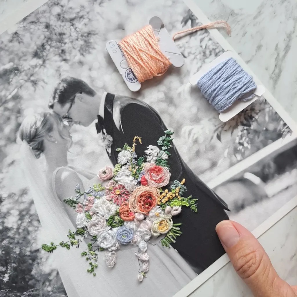 Embroidered bouquet on a picture of a man and woman embracing by Katia Herrera