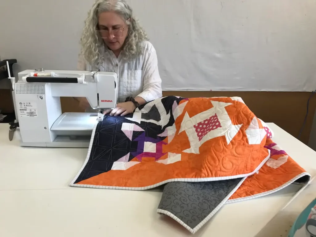 Michelle Freedman working on her quilt Nevermore
