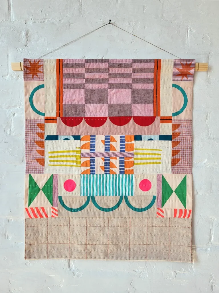 Pink and red wall hanging by Miesje Chafer