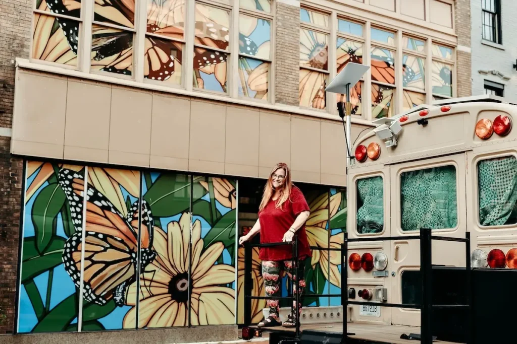 Nikki May on the back porch of her bus