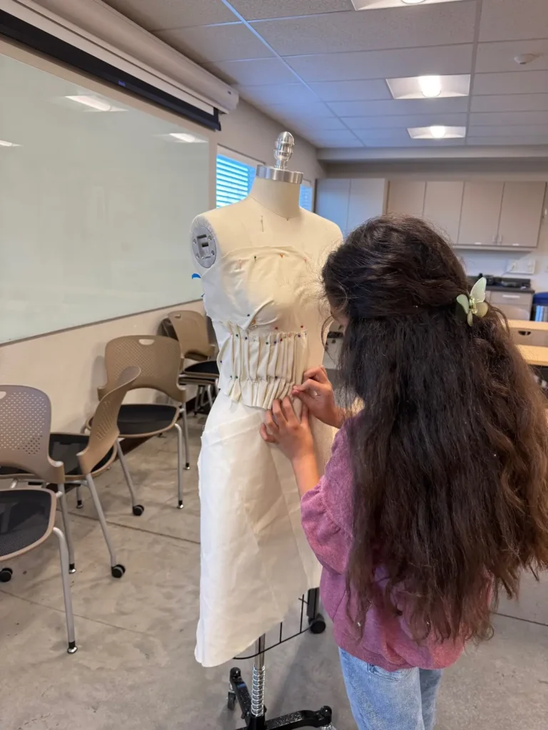 A student working on draping in a class with Qristy Kurtz