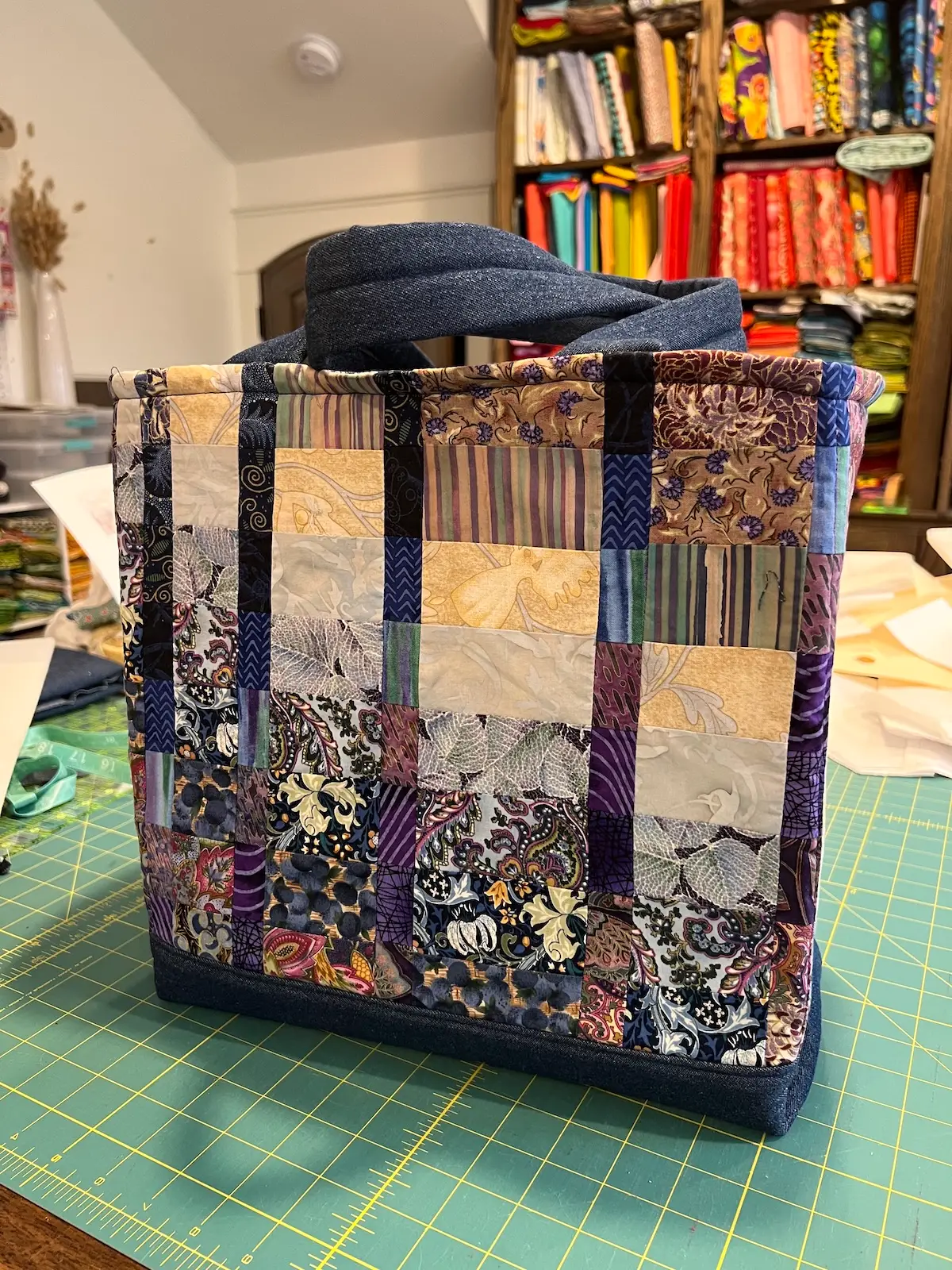 Blue patchwork bag finished on cutting table