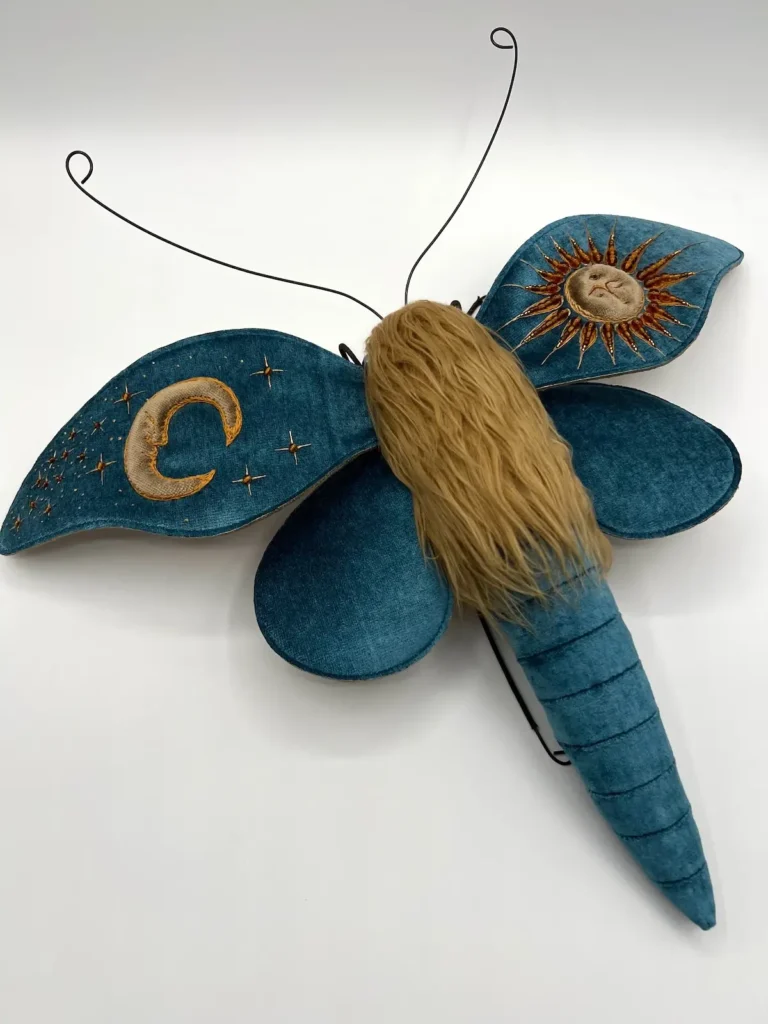 Turquoise sun and moon cloth moth by Larysa Bernhart