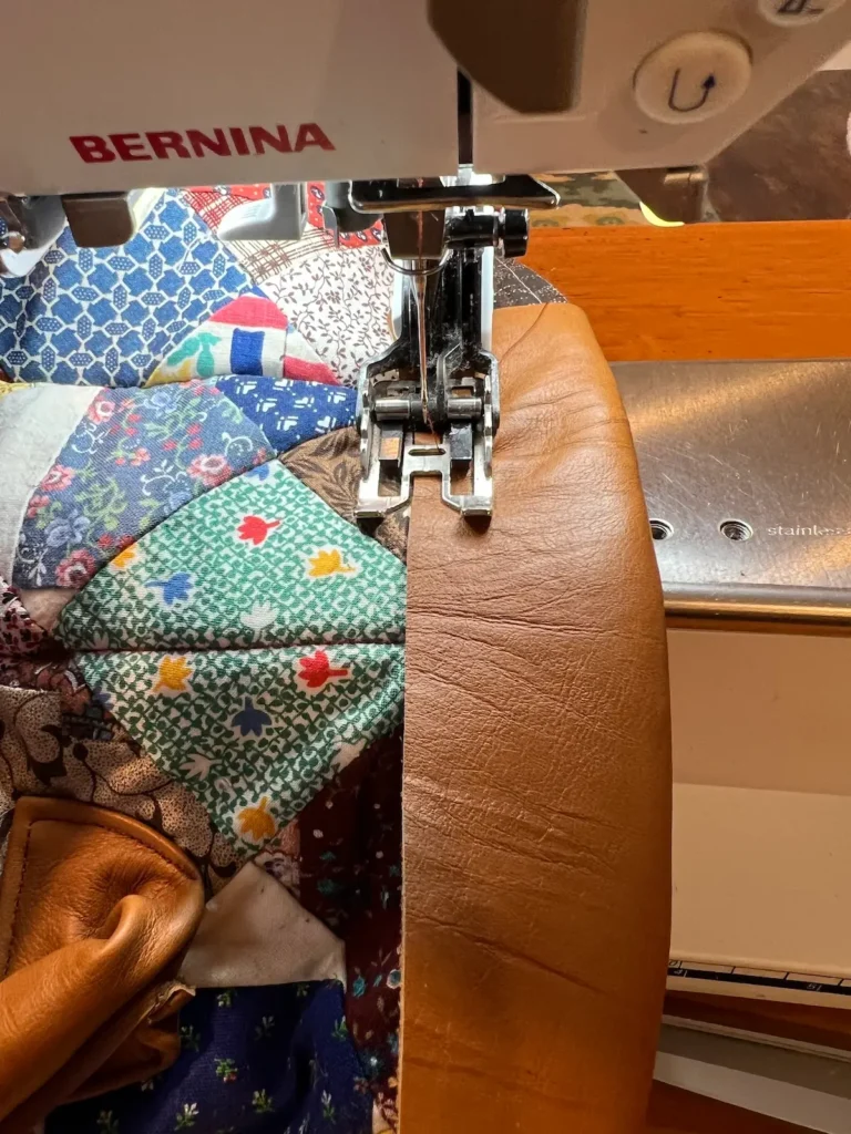 patchwork tote topstitching the leather top to the right side of the bag