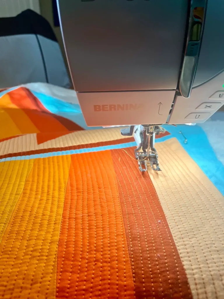 Candi Lennox quilting on her Bernina wiith a walking foot