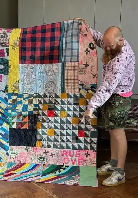 Chris English showing a quilt with printed True Love