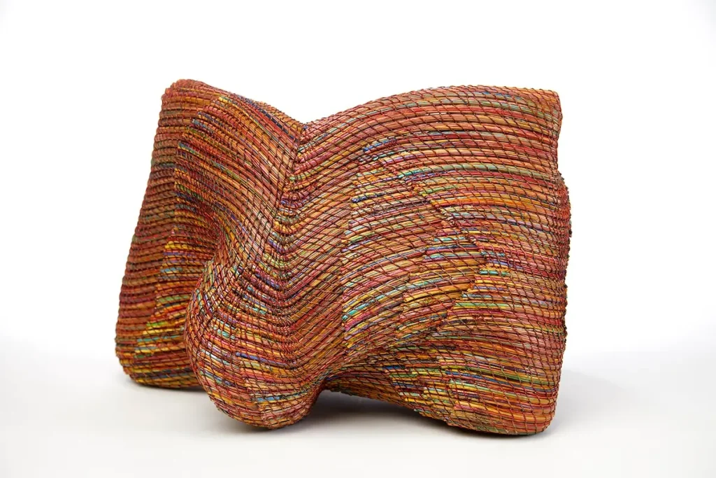 Red tone woven pine needle basket woven by Clay Burnette