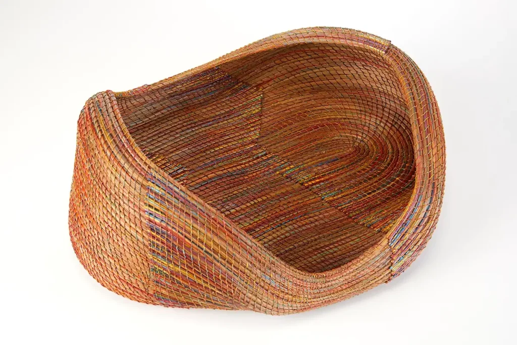 Looking at the inside of a pine needle basket woven by Clay Burnette