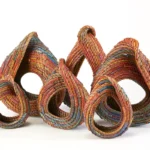 Set of six pine needle structures woven by Clay Burnette