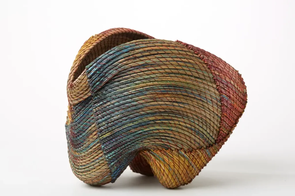 Blue tint on a pine needle basket woven by Clay Burnette
