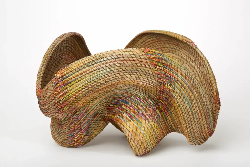Straight on view of a 3D pine needle woven structure by Clay Burnette