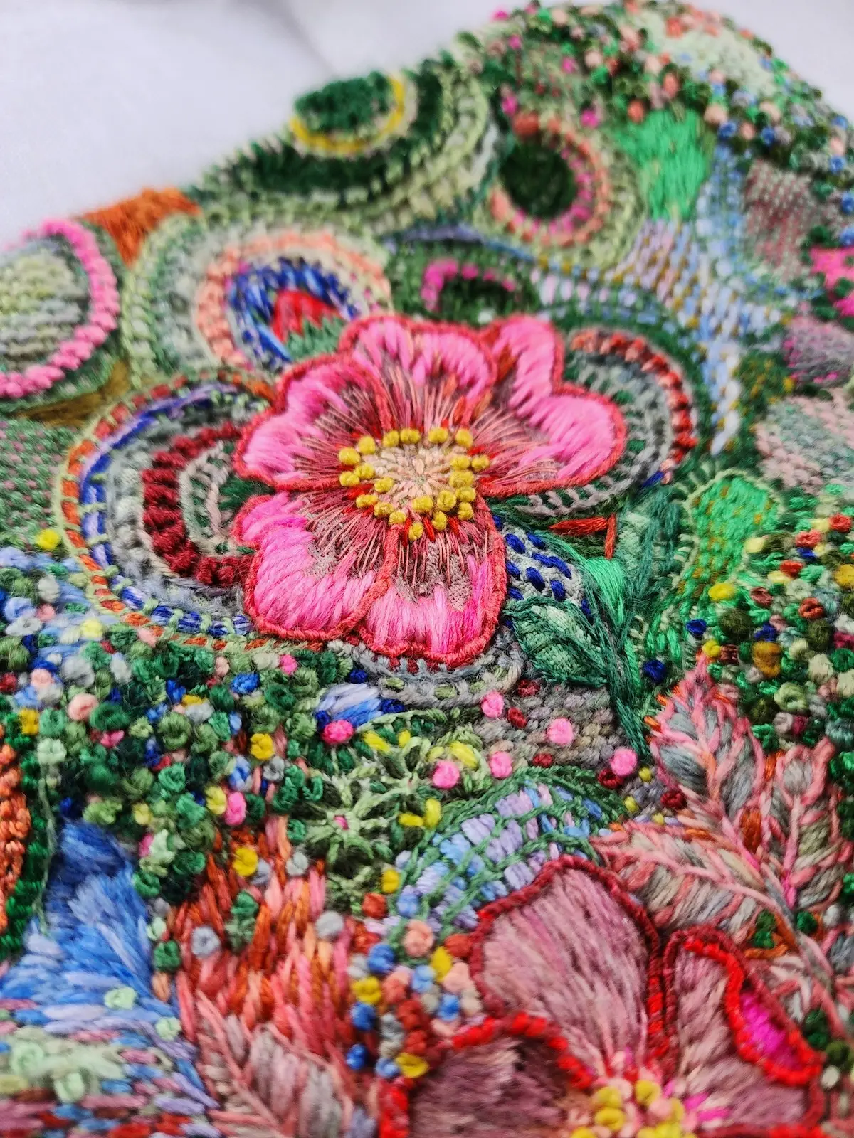 Detail of a pink embroidered flower by Fleur Woods