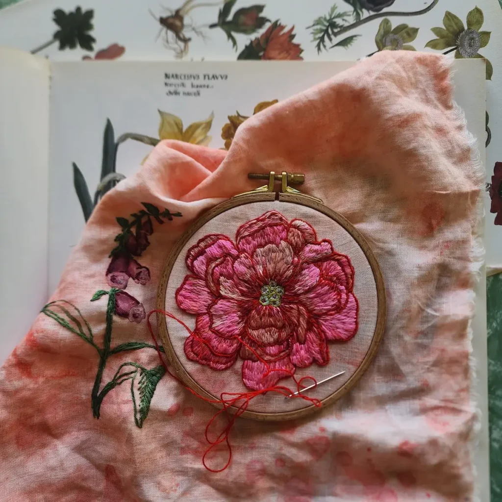 Pink embroidered flower in a hoop by Fleur Woods