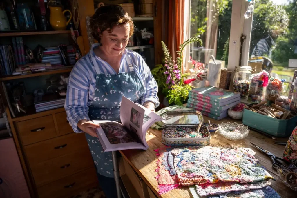 Fleur Woods at a windowsill filled with supplies