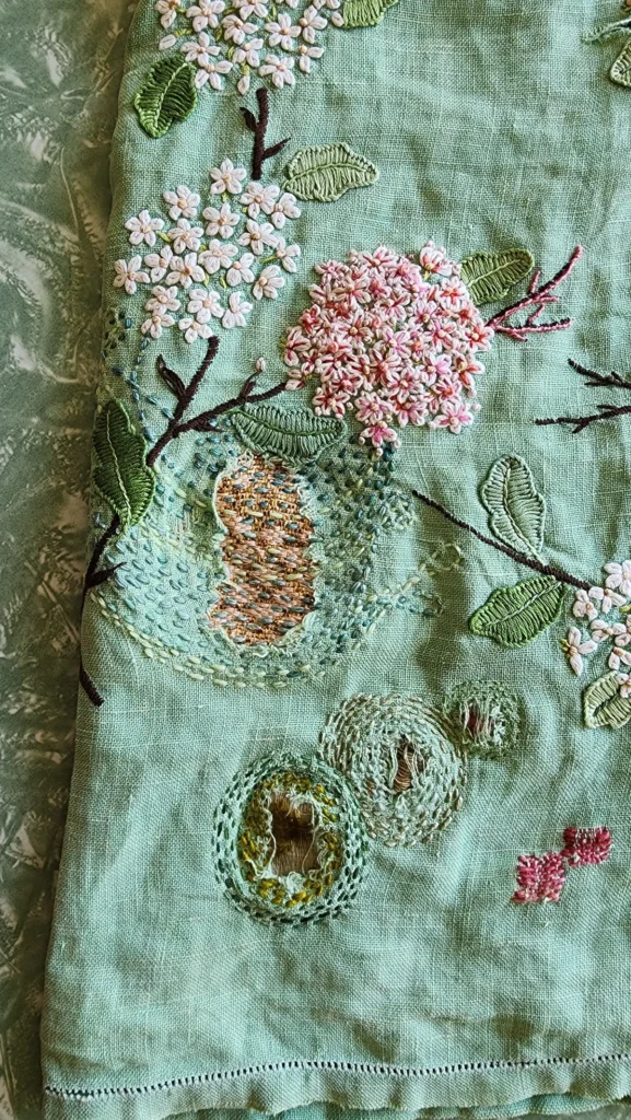 Delicate stitching on great grandmothers table cloth by Fleur Woods