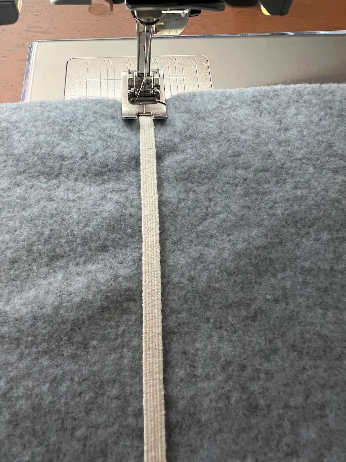 Golf club head covers start by securing the end of th elastic to the wrong side of the lining